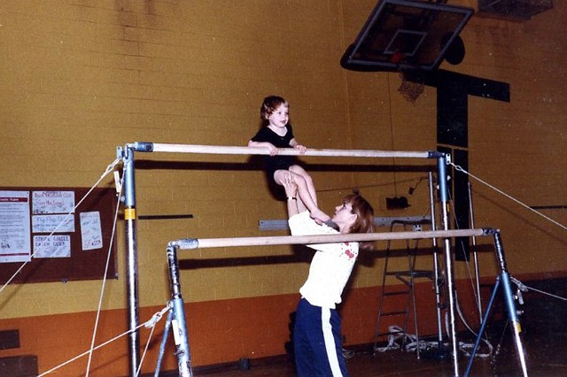 Julie_112 copy.jpg - Gymnastics was a large part of your life for many years.  The skills and coordination you gained through gymnastics enabled you as you grew older to successfully participate in soccer, softball, and cheerleading ... and any other sport you attempted.  Here Mary, one of your early instructors / coaches, works with you.